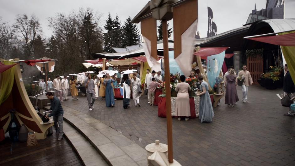 Kara walks through the busy marketplace.