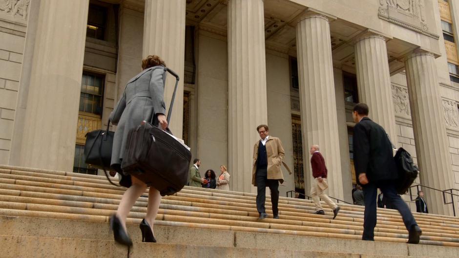 Bull walks down the steps to meet Liberty who is stuggling up with her bags.