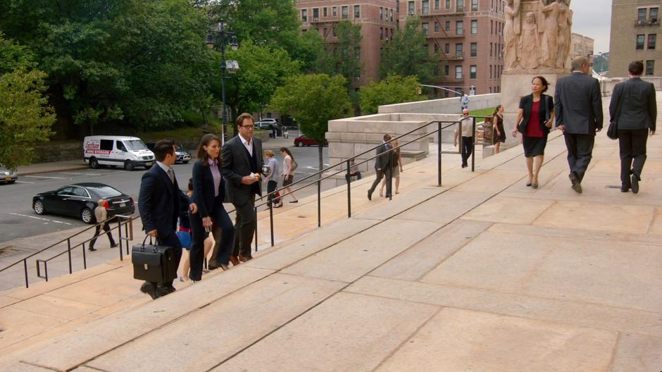 Benny, Captain Mathison, and Bull talk while walking up the steps to the courthouse.