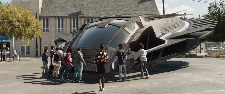 Shuri runs up to the group of kids who have gather around her aircraft that just landed in the lot.