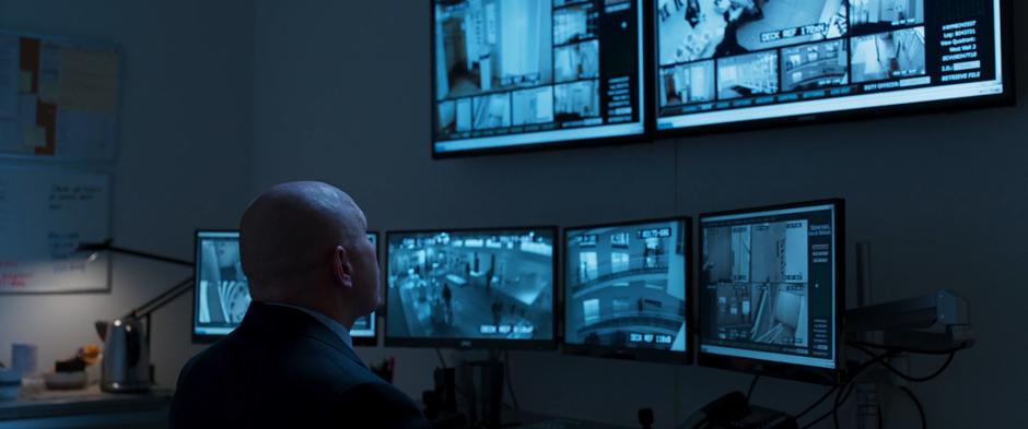 A security guard watches the looped camera feeds.