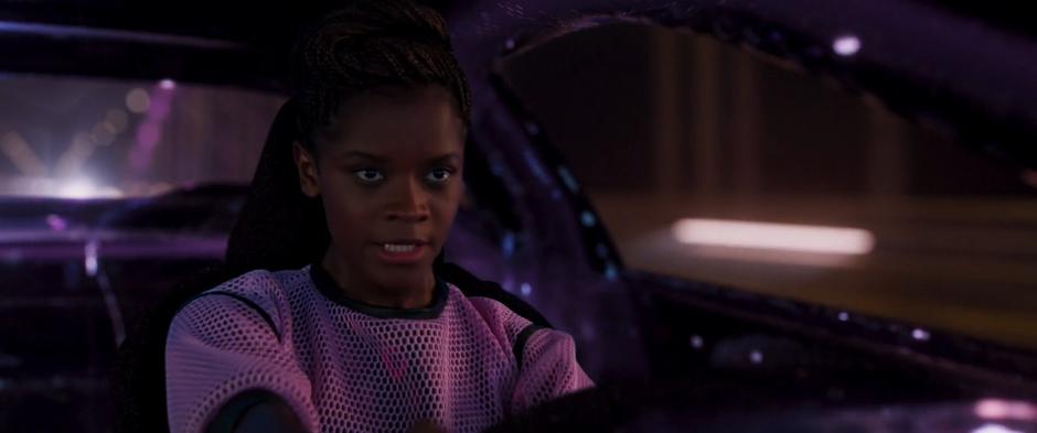Shuri controls the car from inside her virtual simulation.