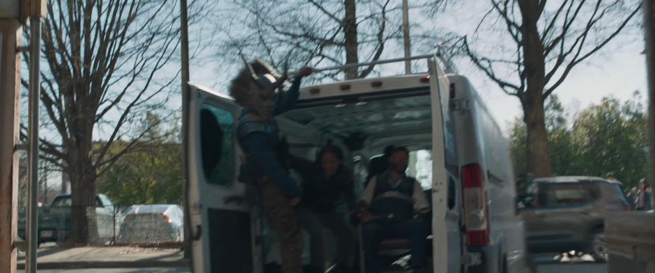 Killmonger leans from the back of the van as it drives away with Ulysses Klaue.