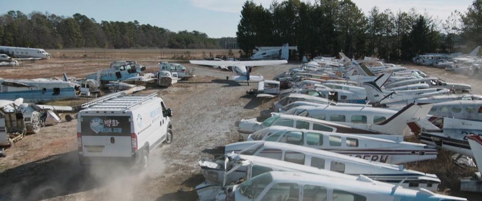 The van pulls up to a waiting airplane.