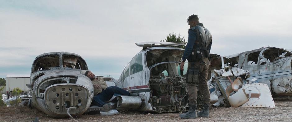 Killmonger stands over Ulysses Klaue after shooting him in the gut.