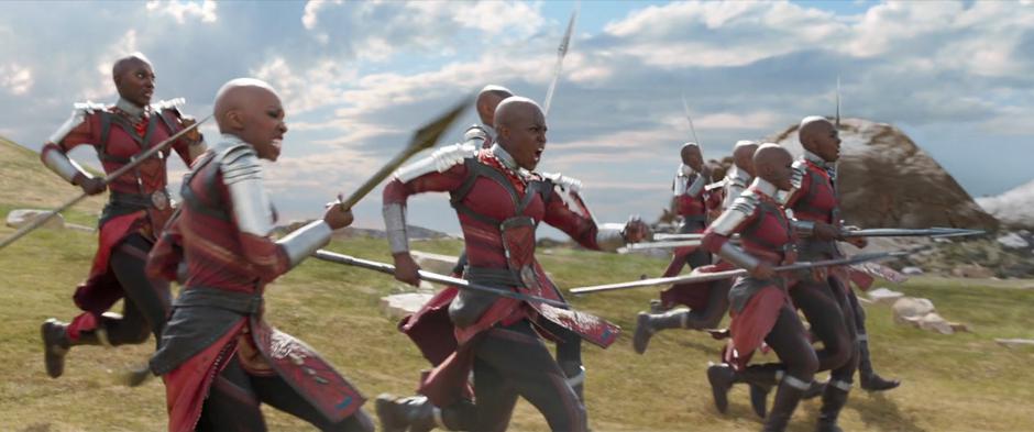 The Dora Milaje race down the field to protect their king.