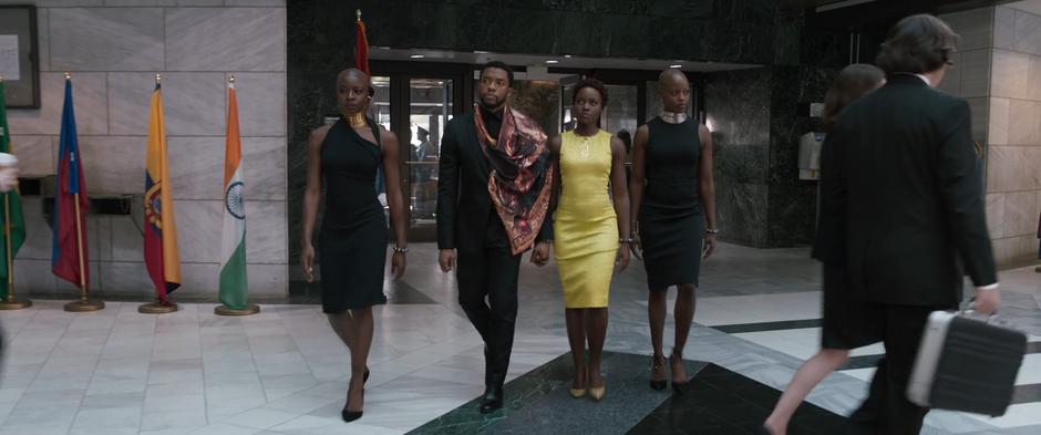 Okoye, T'Challa, Nakia, & Ayo walk into the United Nations building.