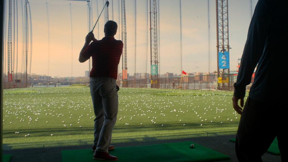 Troy Dickerson watches as his father hits a ball.