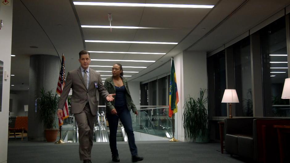 Jeff Hill leads Danny to a conference room while explaining that no Ethiopian laws were broken.