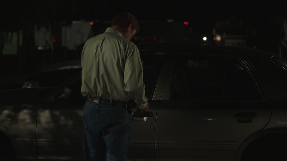 Connors tries to open the door of his car.