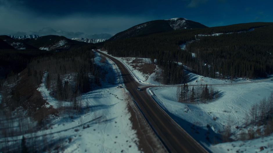 Wynonna's truck drives through the snowly landscape.