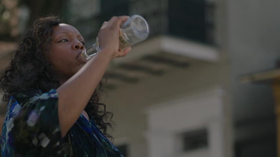 Auntie Chantelle takes a big swig from her rum bottle.