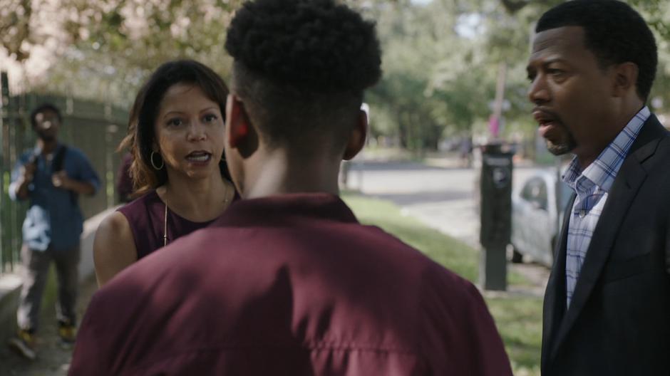 Adina stops and turns back to Tyrone while Otis watches.