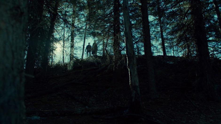 Bulshar and his lieutenant stand at the top of the hill looking down at Wynonna, Nicole, and Doc.