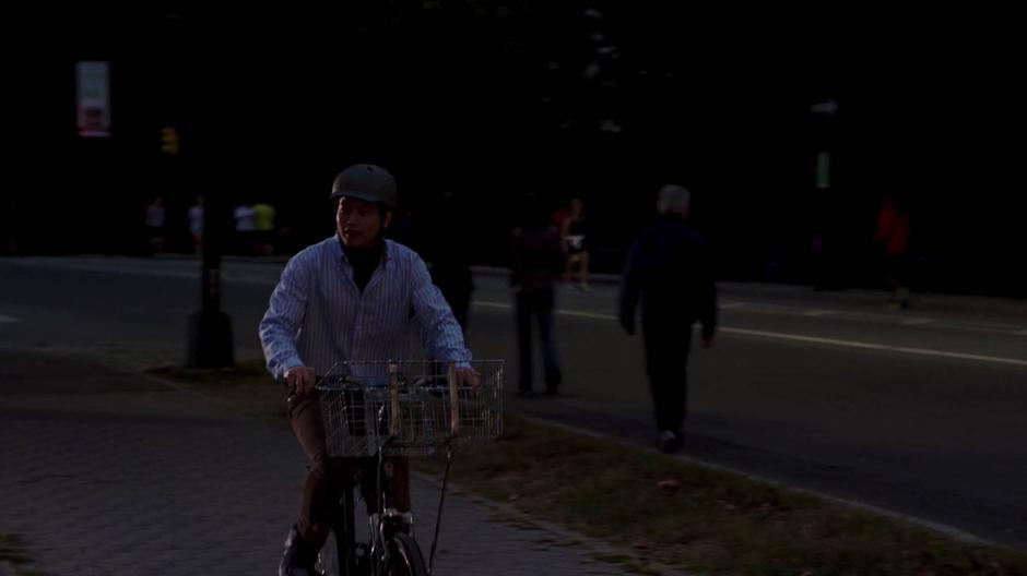 Dong rides his bike down the sidewalk and spots Kimmy in the restaurant.