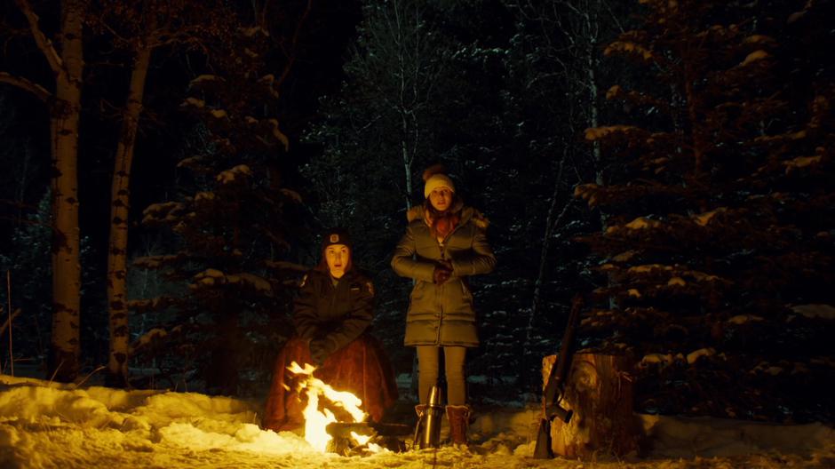 Nicole and Waverly watch Wynonna break down from by the fire.