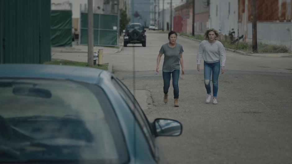 Mina and Tandy walk down the street towards the Roxxon control facility.