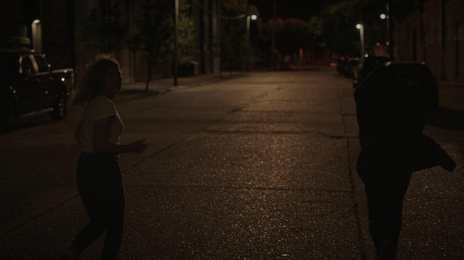 Tandy and Tyrone run down the street towards their destination.