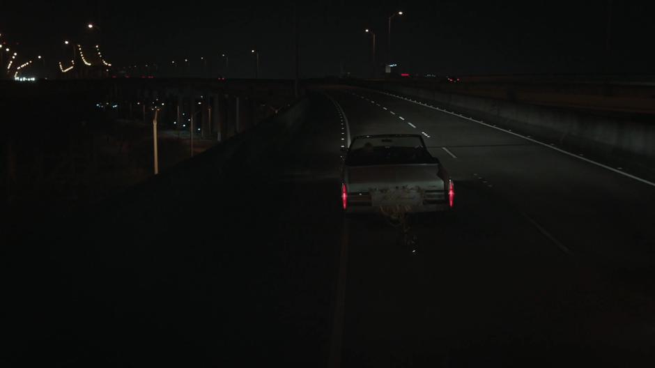 Tandy drives the stolen car up onto the bridge.