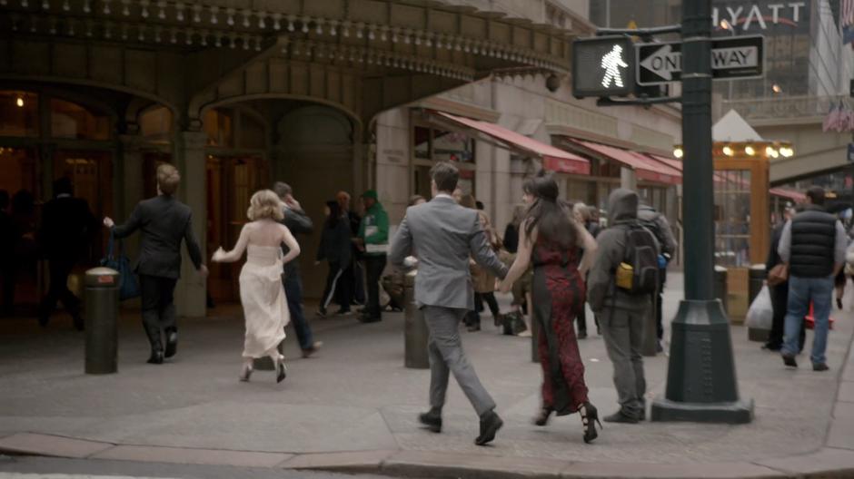 The gang walks into the corner entrance of the station.