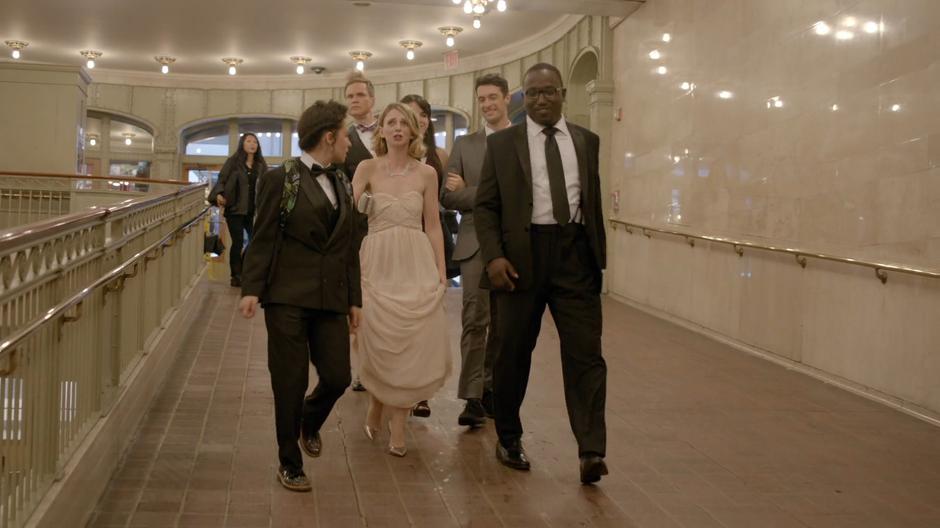 The gang walks down the ramp leading into the atrium.