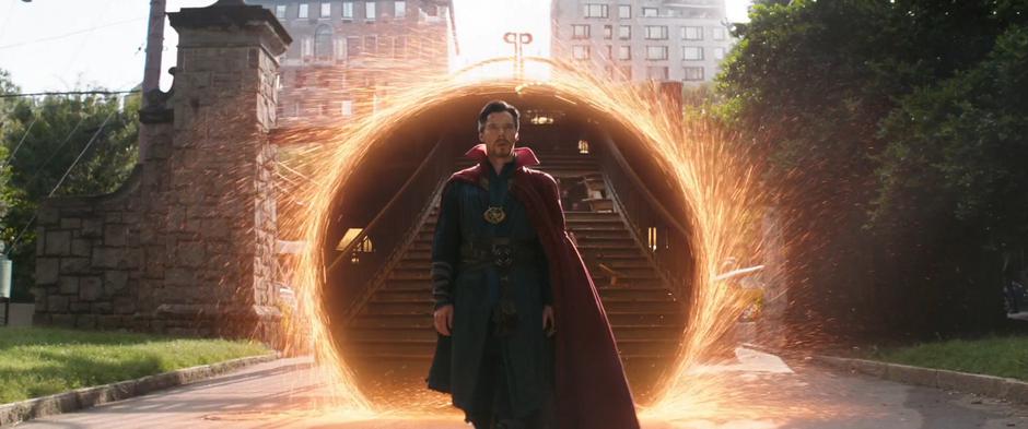 Doctor Strange steps out of his portal into the park.