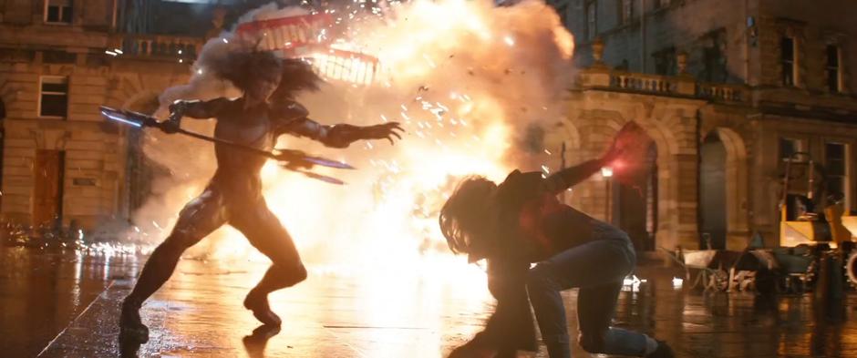 Wanda fights with Proxima Midnight while a truck explodes in the background.