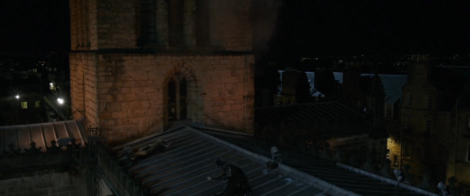 Vision and Corvus Glaive land on the roof of the cathedral.