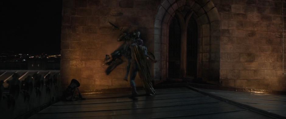 Vision pushes Corvus Glaive against the side of the cathedral tower.