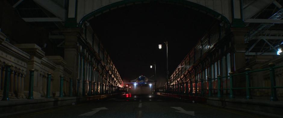 The Quinjet lands on the ramp leading out of the train station.