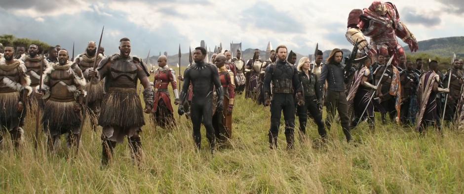 M'Baku assembles his soldiers at the front line next to T'Challa and the others.