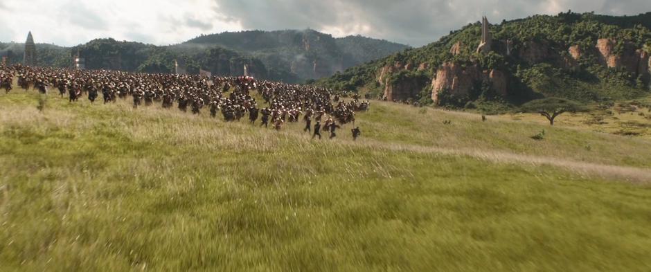 The Wakandan soldiers charge down across the hillside.