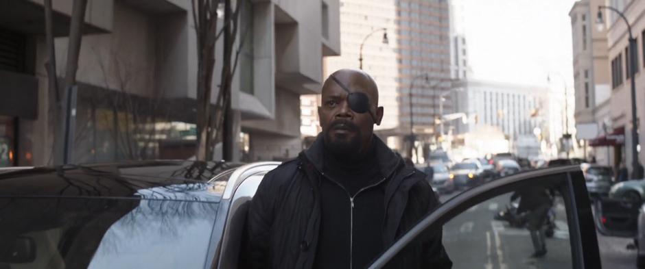 Nick Fury steps out of his car after a SUV swerves to a stop in front of his car.