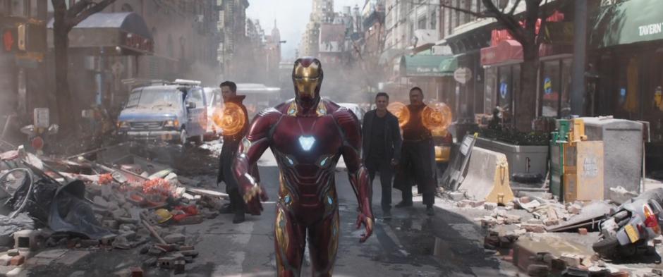 Tony starts down the street after his suit deploys while Doctor Strange and Wong prepare their magic and Bruce watches.