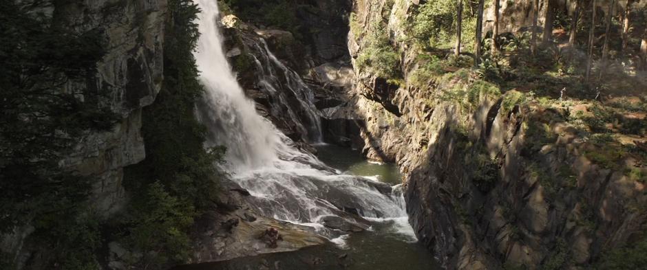 Cull Obsidian and Bruce in the Hulkbuster suit land at the base of the waterfall.