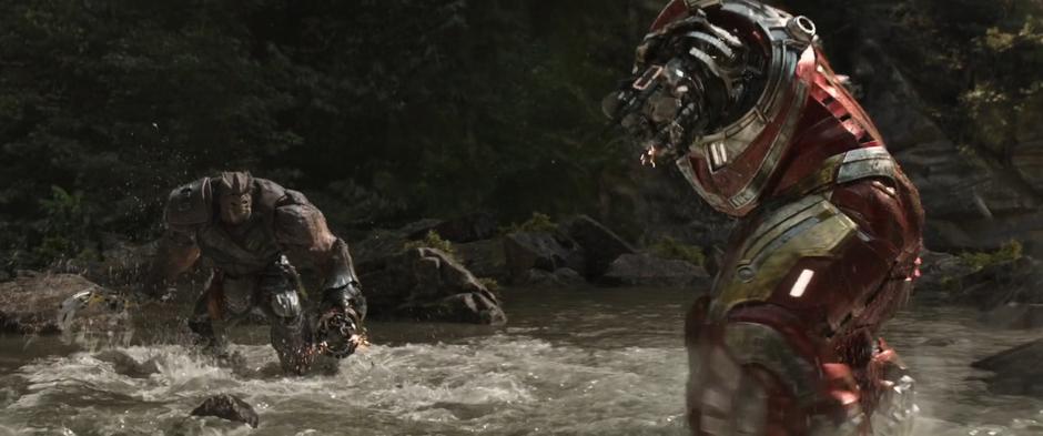 Cull Obsidian and the Hulkbuster suit face off across the water.