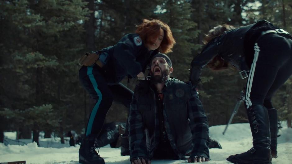 Nicole and Wynonna use their handcuffs to strangle one of the Revenants.