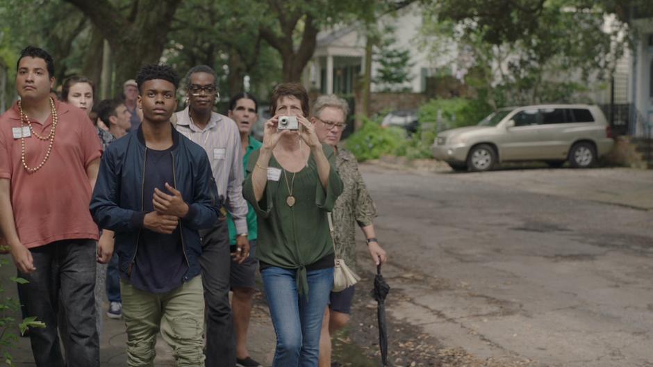 Tyrone walks at the front of the tour group.