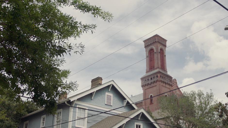 St. Teresa's church sits in the distance beyond a house.