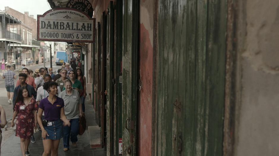 Evita leads the tour group into her family's shop.