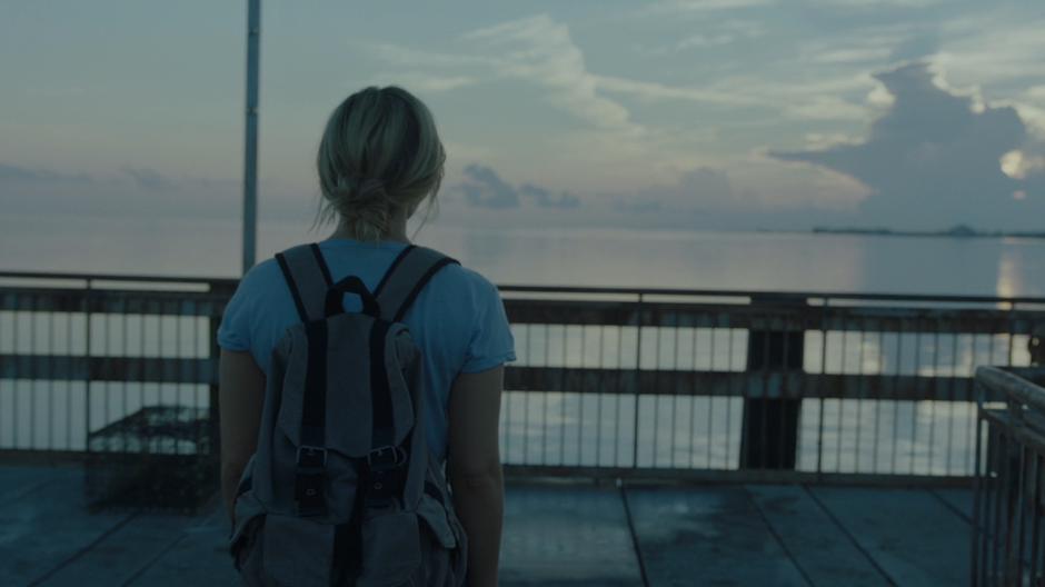 Tandy walks down to the end of the dock.