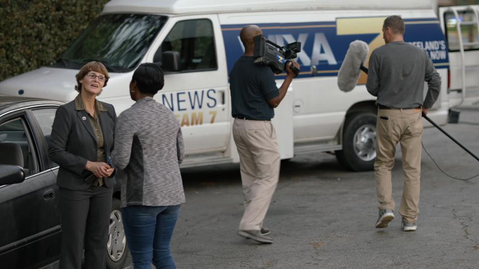 Lawanda talks to a news reporter after her interview out front.