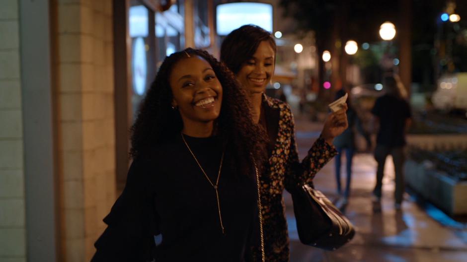 Anissa smiles while leaving the building with Chenoa.