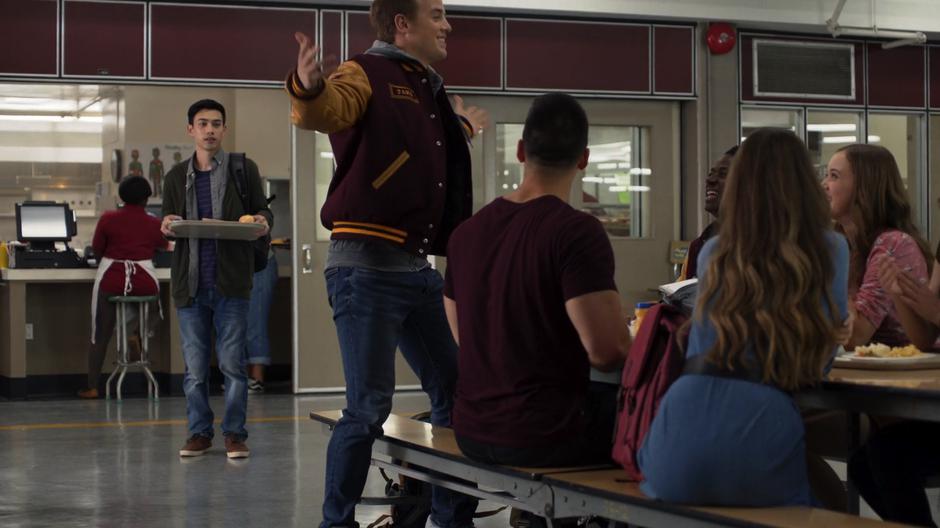 Kenny Li looks around the cafeteria after getting his food.