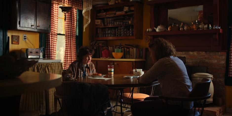 Eleven talks to Becky Ives at the kitchen table after seeing her mother's memories.