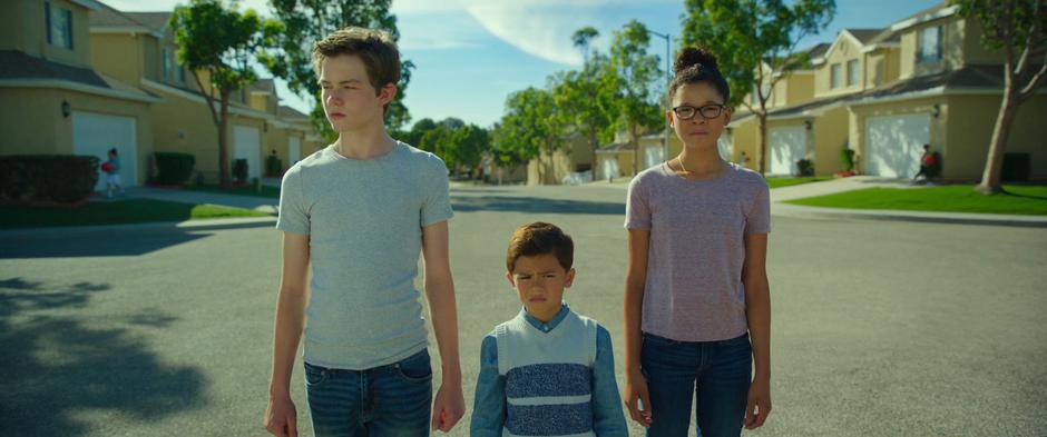 Calvin, Charles Wallace, and Meg look around the neighborhood.