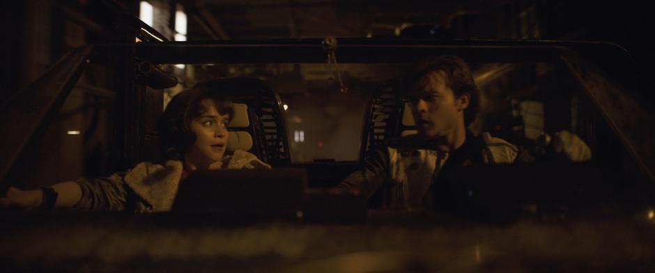 Qi'ra and Han share a look while racing down the tunnel in the speeder.