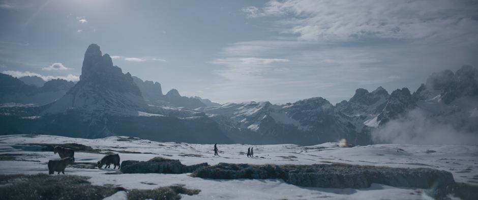 Chewbacca, Han, and Beckett walk across the plateau while some animals graze in the foreground.