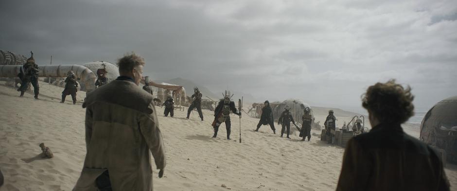 Beckett and Han step outside to where Enfys Nest and the Cloud Riders are spread out.