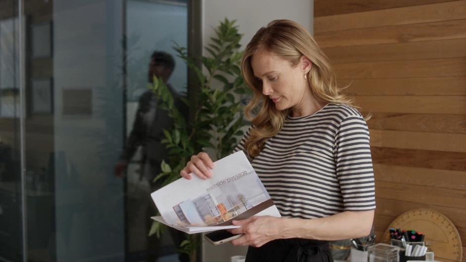 Emma goes over some documents in her office before her meeting.